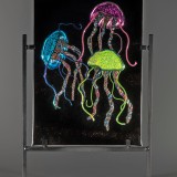 Glass art panel with three colorful jellyfish