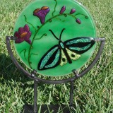 Round green stained glass plate with butterfly