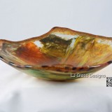 Handmade fused glass bowl with amber swirls
