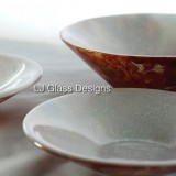 Three decorative glass bowls on white cloth