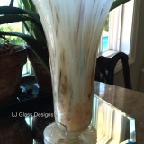 Tall marbled glass vase on mirrored base